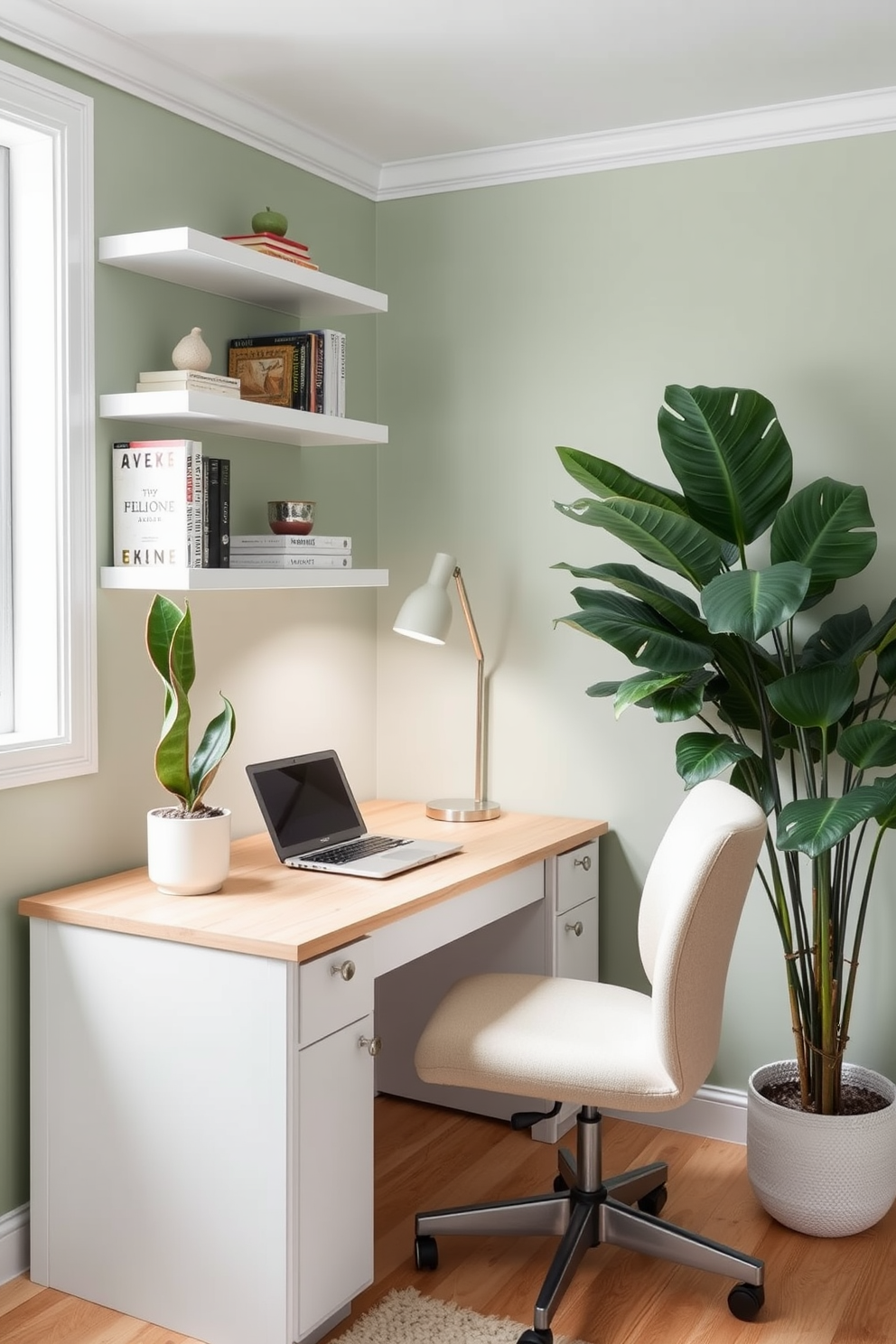 A cozy small home office with a light wood desk positioned against a window. The desk is adorned with a laptop, a potted snake plant, and a stylish desk lamp. Soft green walls create a serene atmosphere, complemented by white shelves filled with books and decorative items. A comfortable chair upholstered in a neutral fabric sits at the desk, while a large leafy plant adds life to the corner of the room.