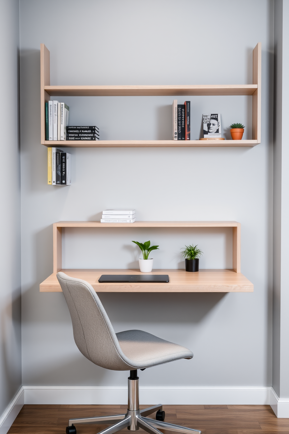 A sleek wall-mounted desk is positioned against a light gray wall, featuring clean lines and a minimalist aesthetic. Above the desk, open shelving displays stylish books and decorative items, enhancing the functional yet modern look. The office chair is a contemporary design with a soft fabric in a muted color, providing comfort and style. A small potted plant sits on the desk, adding a touch of greenery to the compact workspace.