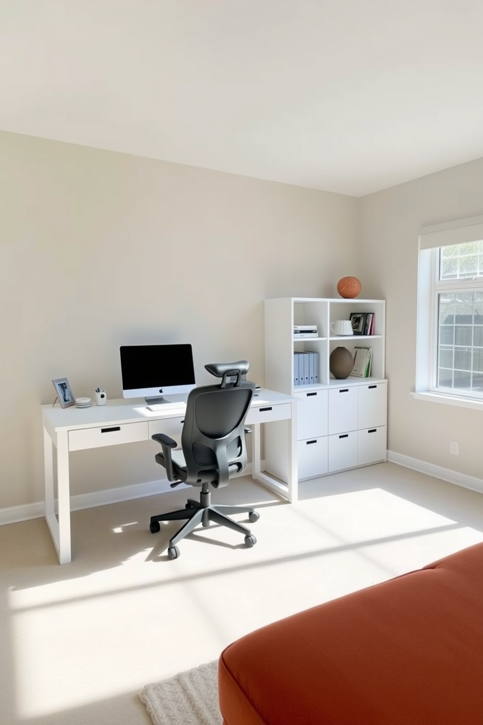 A minimalist home office with clean lines and an airy feel. The space features a sleek white desk paired with a comfortable ergonomic chair, bathed in natural light from a large window. The walls are painted in a soft beige hue, enhancing the sense of openness. A simple bookshelf with a few select decorative items adds a touch of personality without cluttering the space.