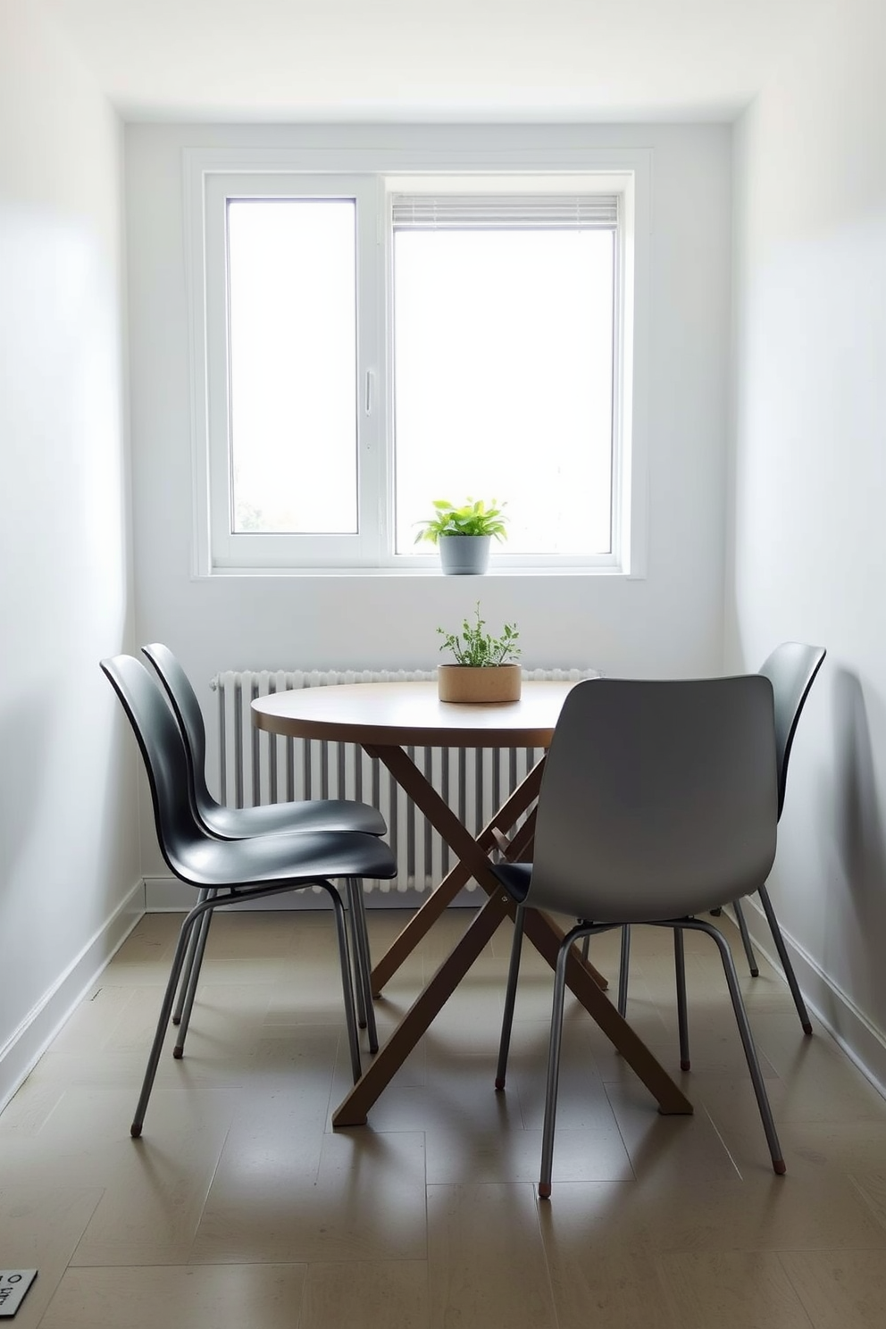 A cozy kitchen dining area features a foldable table that can be easily adjusted to accommodate guests. Surrounding the table are sleek, modern chairs that complement the minimalist design of the space. The walls are painted in a soft white, enhancing the natural light that floods the room. A small potted herb garden sits on the windowsill, adding a touch of greenery and freshness to the atmosphere.