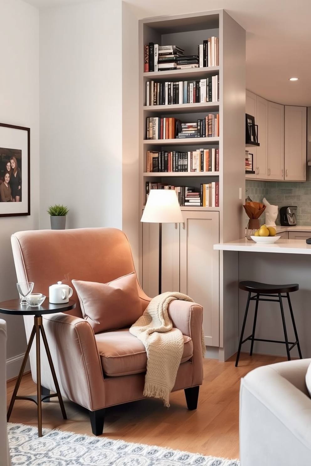 A cozy reading nook corner features a plush armchair upholstered in soft fabric, positioned next to a tall bookshelf filled with an array of books. A small side table holds a steaming cup of tea and a decorative lamp, while a warm throw blanket drapes over the arm of the chair. In a small kitchen living room design, an open layout maximizes space with a compact dining table adjacent to the kitchen island. Stylish bar stools provide seating, and modern appliances blend seamlessly with cabinetry in a light color palette, creating an inviting atmosphere.