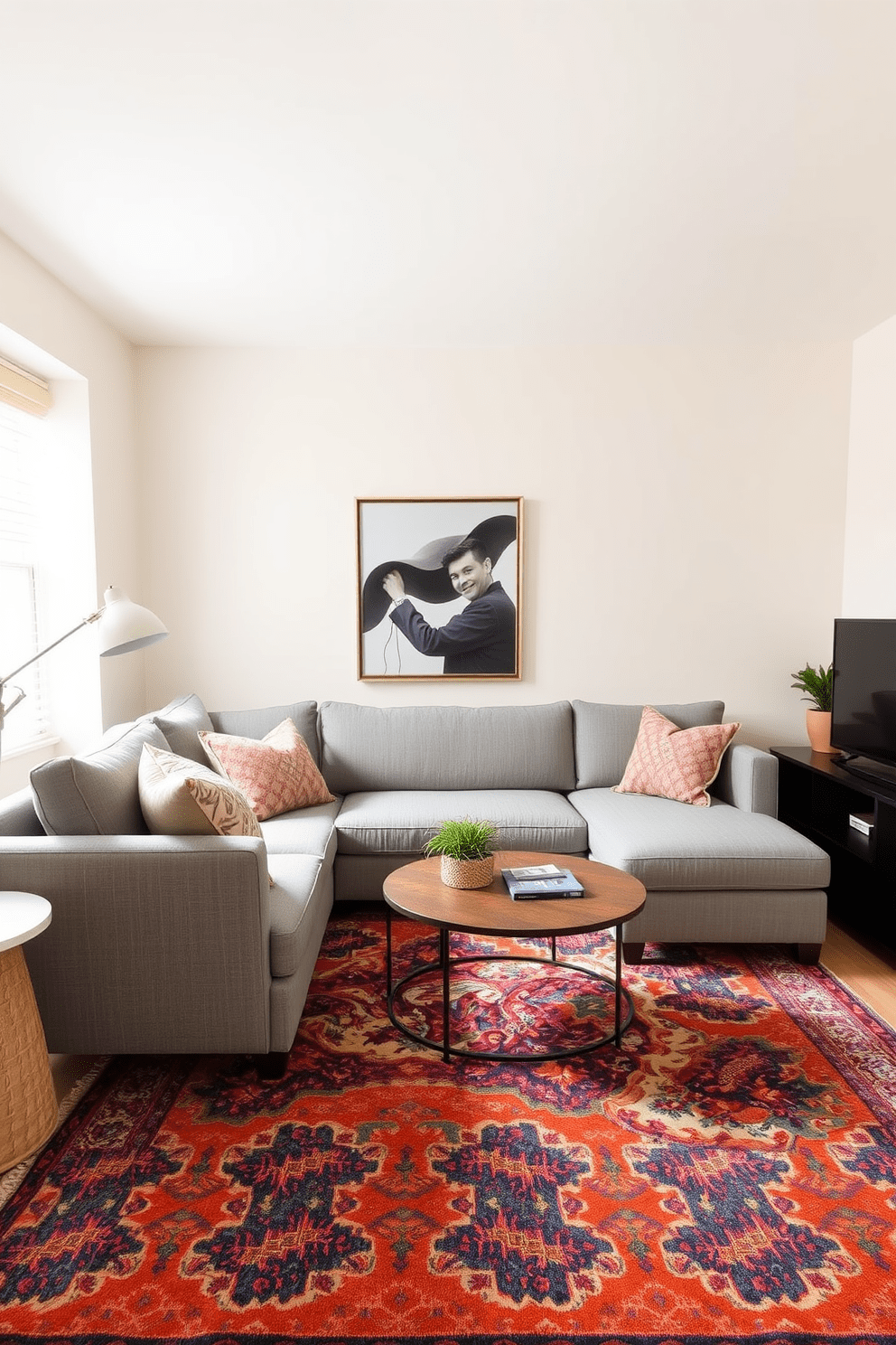 A stylish small living room featuring a sectional sofa that maximizes seating efficiency. The sofa is upholstered in a soft gray fabric and positioned to create an inviting focal point in the room. The walls are painted in a light cream color to enhance the sense of space. A round coffee table sits in front of the sofa, complemented by a vibrant area rug that adds warmth and texture.