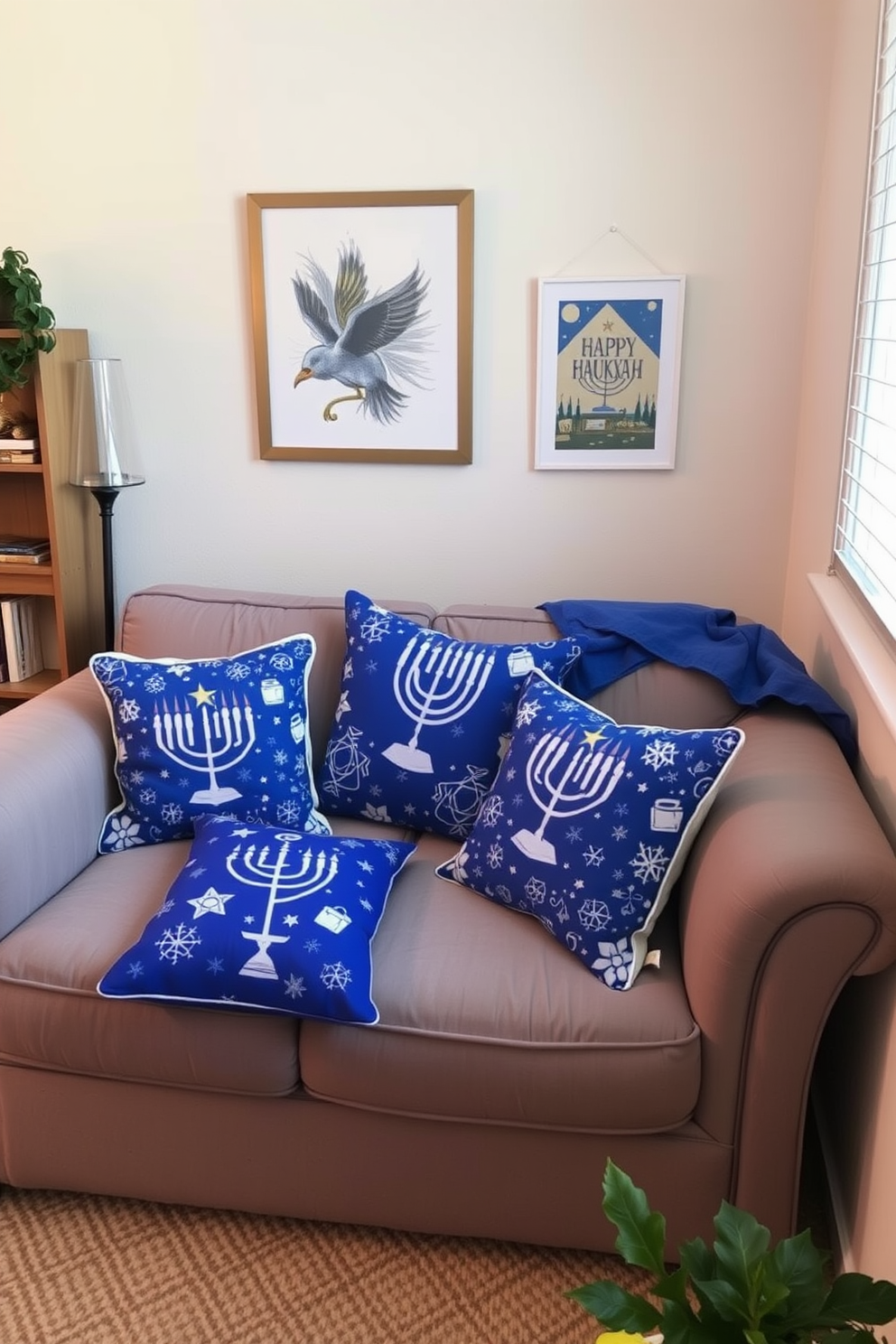 A cozy small living room adorned with Hanukkah-themed cushions on a plush sofa. The cushions feature vibrant blue and white patterns, including menorahs and dreidels, adding a festive touch to the space.