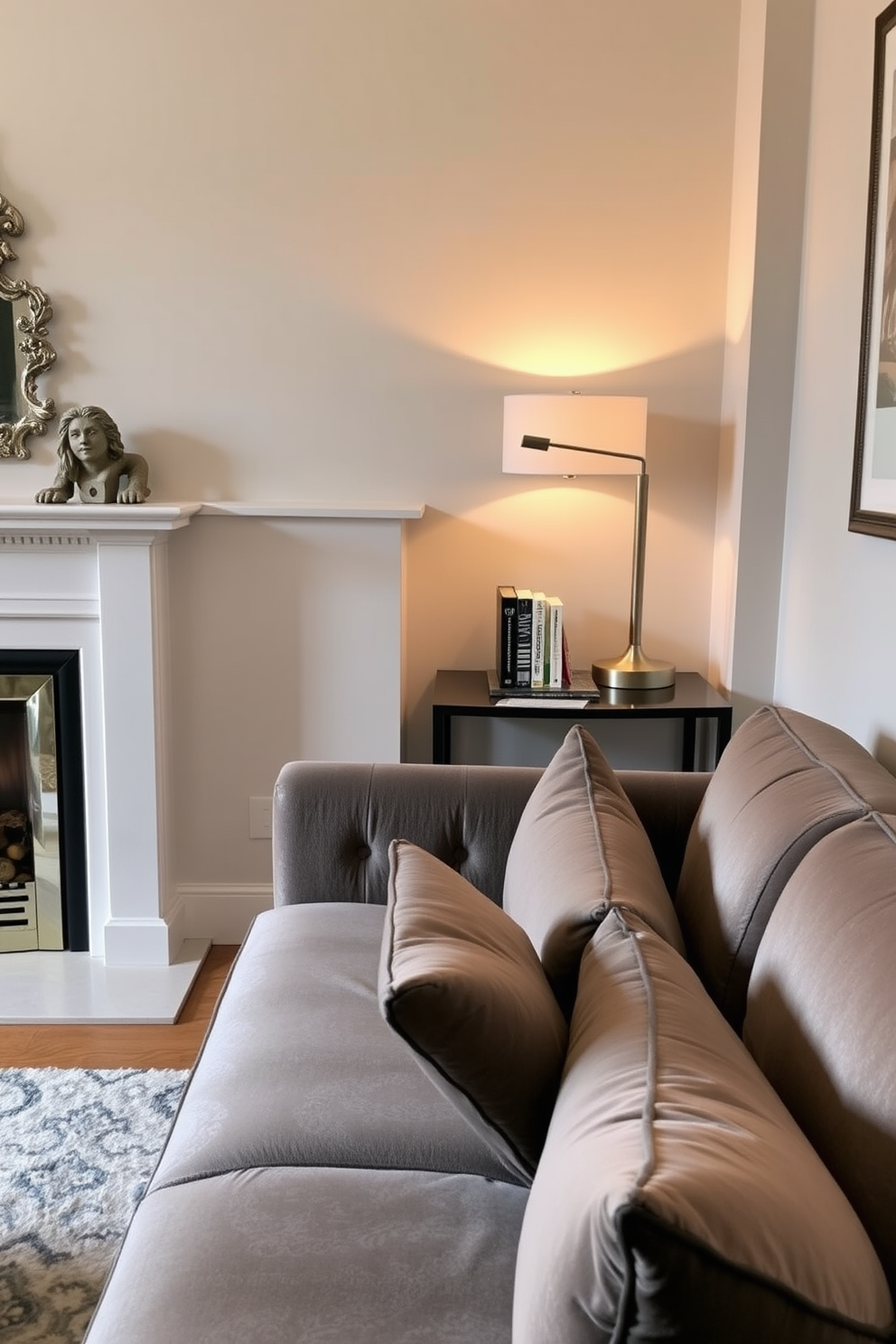 A narrow console table is positioned behind a stylish sofa, enhancing the functionality of the small living room. The table is adorned with decorative items, including a sleek lamp and a few carefully arranged books, creating an inviting atmosphere. To the left of the console table, a cozy fireplace serves as the room's focal point, framed by elegant mantel decor. Soft, warm lighting from the fireplace casts a gentle glow, complementing the rich textures of the sofa and surrounding furnishings.