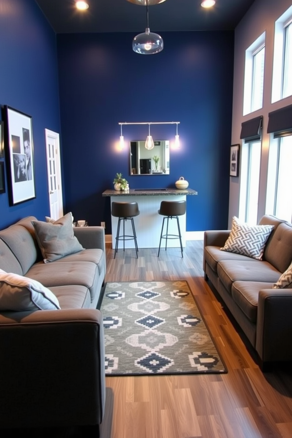 A cozy man cave featuring a deep blue accent wall and plush seating arrangements. A decorative rug with geometric patterns lies at the center, adding warmth and texture to the space. In one corner, a small bar area showcases stylish stools and a sleek countertop. Ambient lighting fixtures create a relaxed atmosphere, perfect for unwinding after a long day.