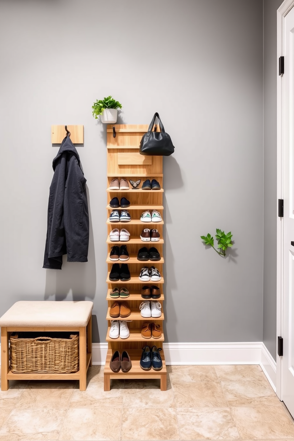 A vertical shoe rack made of natural wood stands against the wall, maximizing space while providing a stylish storage solution. The mudroom features a light gray color palette with a durable tile floor, complemented by a cozy bench for putting on shoes. Hooks for coats and bags are mounted above the shoe rack, ensuring an organized entryway. A small potted plant adds a touch of greenery, enhancing the welcoming atmosphere of the mudroom.