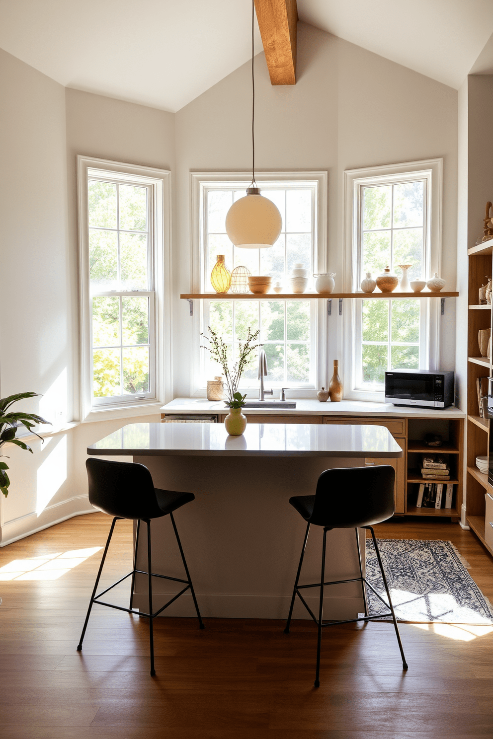 A cozy small office kitchen bathed in natural light streaming through large windows. The space features a compact island with a sleek countertop, surrounded by stylish bar stools, and open shelving displaying curated dishware.