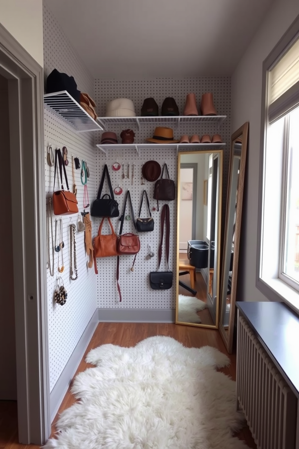 A stylish small walk-in closet featuring a pegboard on one wall for organizing accessories. The pegboard is adorned with hooks and shelves displaying handbags, jewelry, and hats, creating an efficient and visually appealing storage solution. The remaining walls are painted in a soft, neutral tone to enhance the sense of space. A plush area rug lies on the floor, and a full-length mirror is positioned to reflect the natural light from a nearby window.