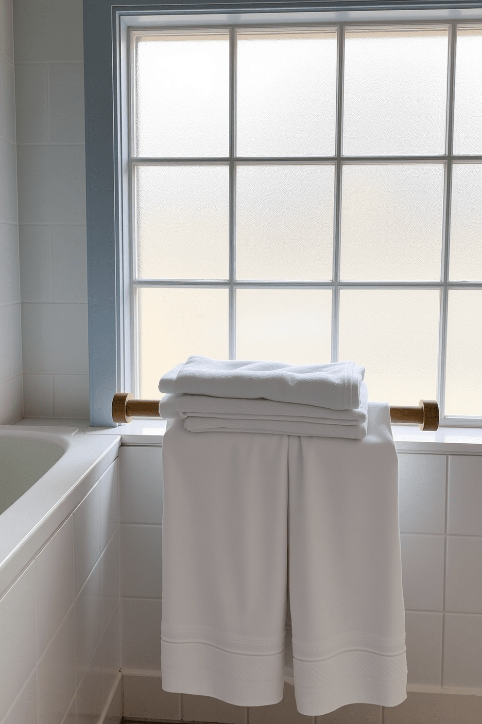 A serene spa bathroom setting featuring organic cotton towels neatly arranged on a wooden towel rack. Soft natural light filters through a frosted glass window, illuminating the calming color palette of soft blues and whites.