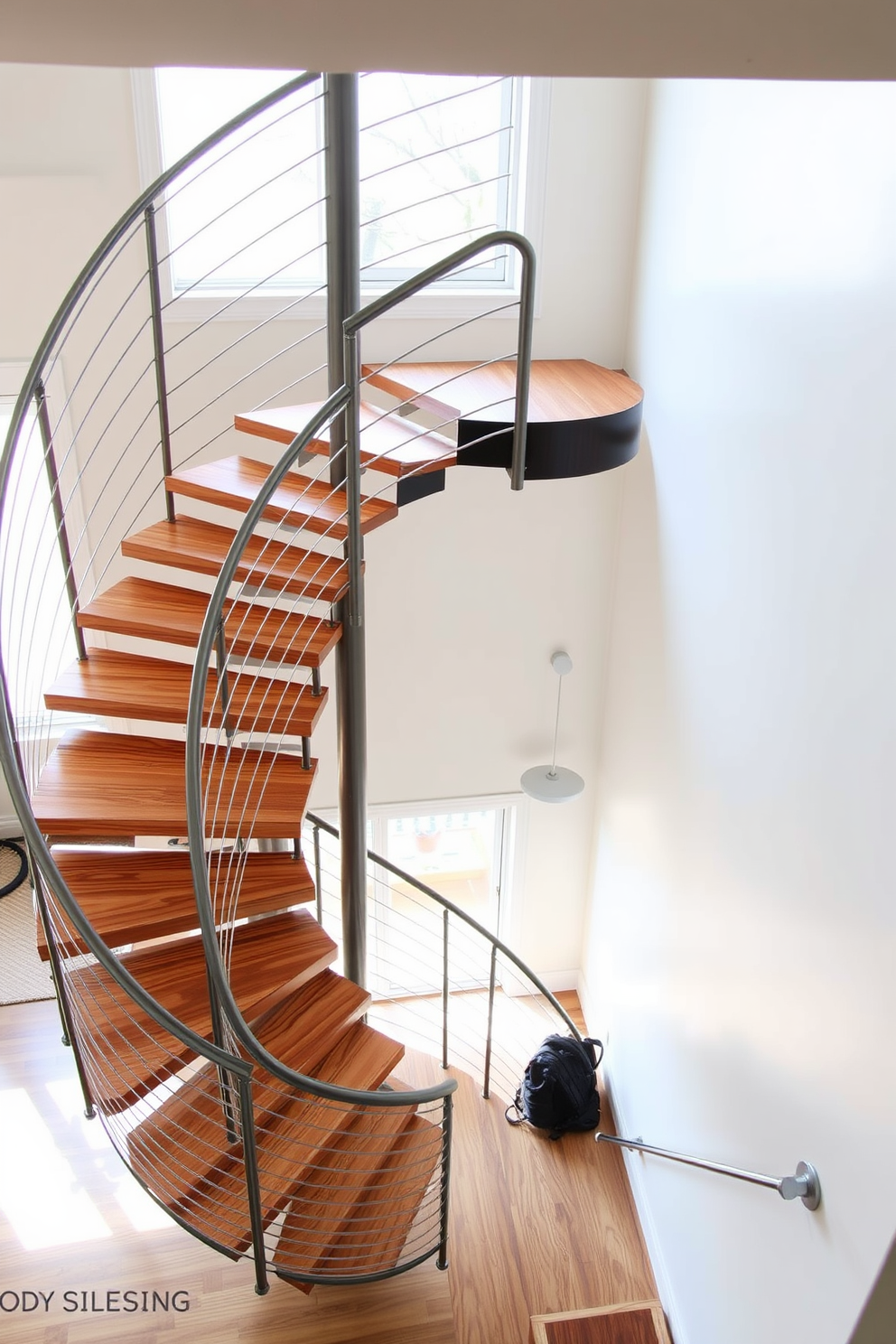 A modern spiral staircase with open treads elegantly ascends to the upper level of the home. The staircase features sleek metal railings and a minimalist design that complements the surrounding decor. Natural light floods the space, highlighting the beautiful wood grain of the treads. The staircase is surrounded by a neutral color palette, enhancing its contemporary aesthetic.