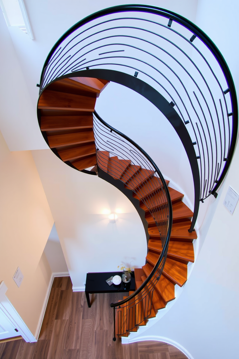 A stunning spiral staircase with sleek metal accents gracefully winds upward. The staircase features a polished wooden tread that contrasts beautifully with the modern metal railings. Soft ambient lighting illuminates the staircase, highlighting its elegant curves and inviting atmosphere. Below, a minimalist entryway with a decorative console table complements the design, creating a harmonious flow.