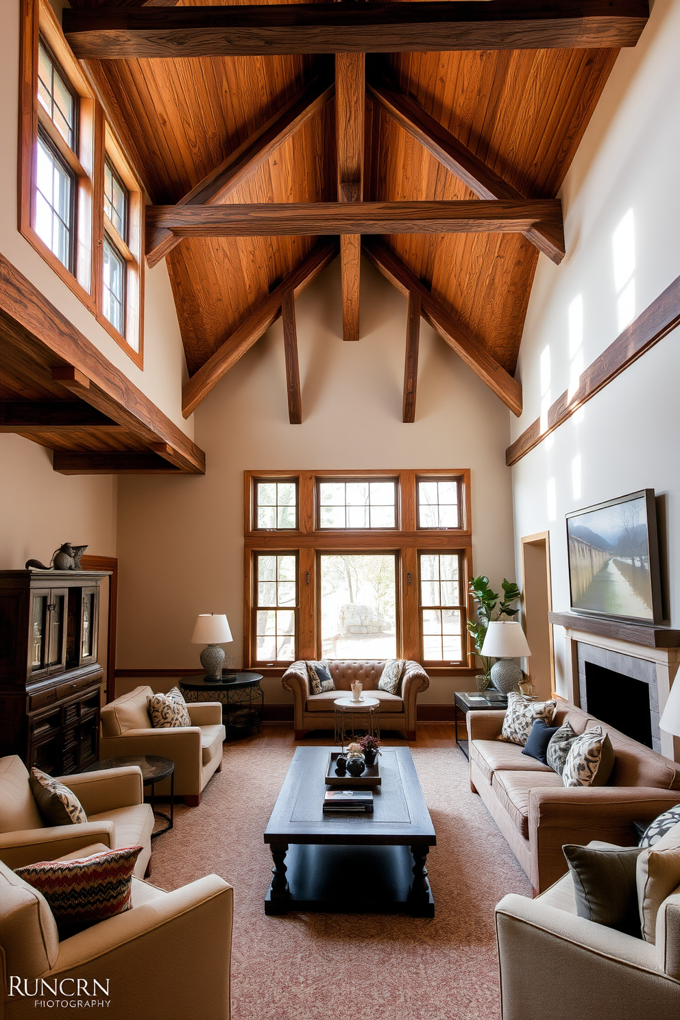 A sunken living room featuring exposed wood beams that add rustic charm to the space. The room is filled with plush seating arranged around a central coffee table, creating an inviting atmosphere for relaxation and conversation.