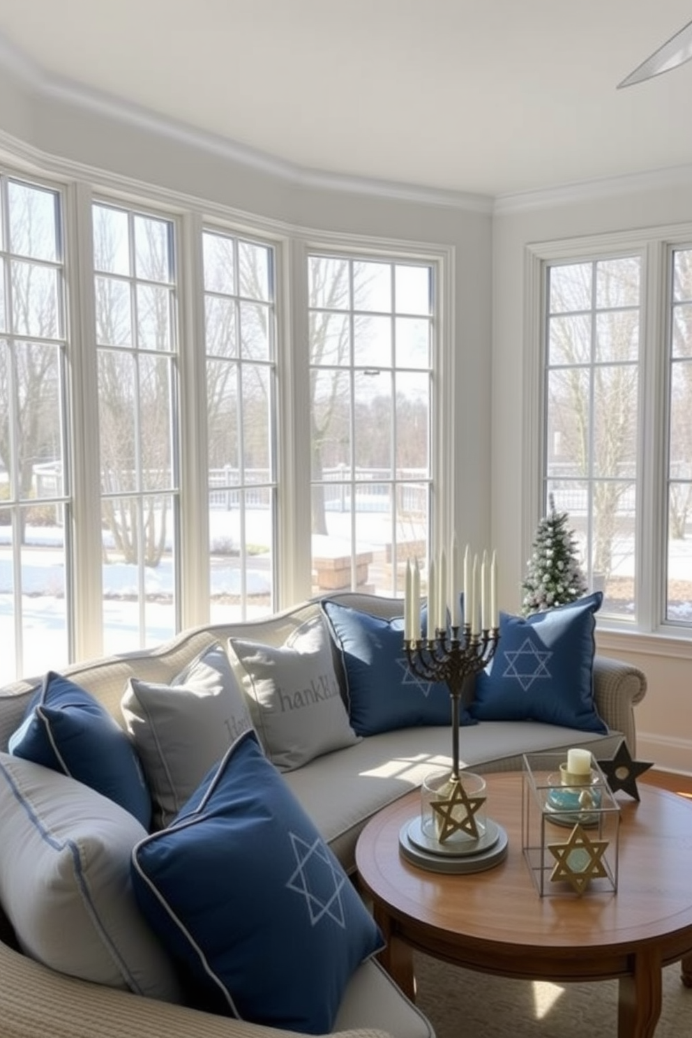 A bright and airy sunroom filled with natural light. The space showcases a cozy seating area adorned with festive Hanukkah-themed cushions in shades of blue and silver. A large window offers a view of the winter landscape outside. Decorative menorahs and star of David accents are tastefully arranged on the coffee table, enhancing the festive atmosphere.