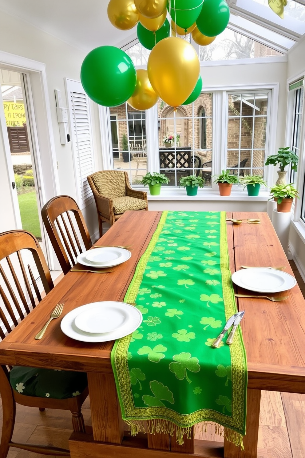 A St Patrick's Day themed table runner features vibrant green fabric adorned with shamrocks and gold accents. The runner is elegantly draped across a rustic wooden dining table, complemented by white dinnerware and gold flatware. In the sunroom, cheerful decorations create a festive atmosphere with green and gold balloons hanging from the ceiling. Potted shamrock plants are placed on the windowsills, enhancing the natural light and cheerful ambiance of the space.