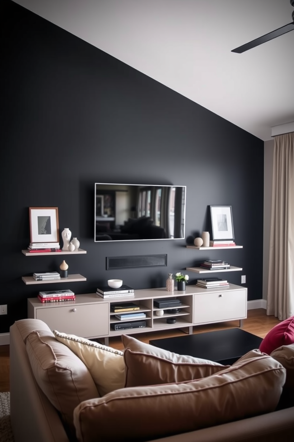 A striking dark accent wall creates a dramatic backdrop for the living room. The wall is complemented by a sleek, modern TV mounted above a stylish media console. Surrounding the TV, minimalist shelving displays curated decor and books. Plush seating in neutral tones invites comfort, while vibrant throw pillows add a pop of color.