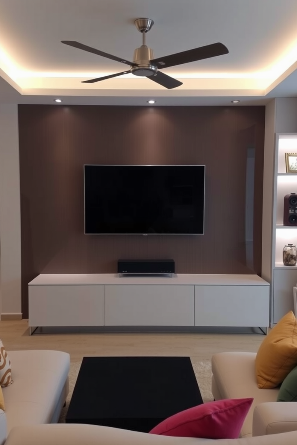 A contemporary living room featuring an integrated lighting system that highlights a sleek wall-mounted television. The space is adorned with a minimalist entertainment unit beneath the TV, complemented by plush seating in neutral tones and colorful accent pillows.