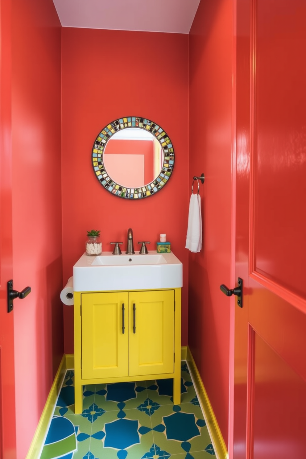 A vibrant and energizing powder room filled with bright colors. The walls are painted in a bold coral hue, complemented by a cheerful yellow vanity with a sleek white sink. A round mirror with a colorful mosaic frame hangs above the vanity. The floor features playful geometric tiles in shades of blue and green, adding a lively touch to the space.