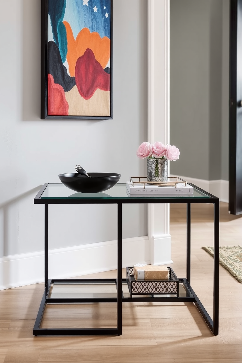 Chic side table for keys and mail in a townhouse entryway. The table is made of sleek black metal with a glass top, featuring a minimalist design that complements the space. A stylish bowl sits on the table for holding keys, while a small decorative tray organizes mail. The walls are painted in soft gray, and a vibrant piece of artwork adds a pop of color above the table.