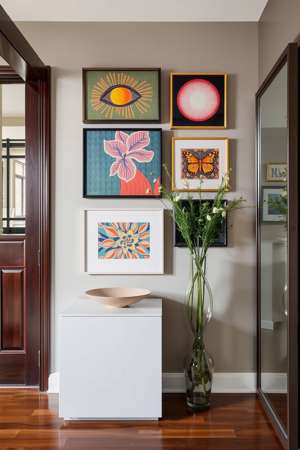 A stylish townhouse entryway featuring a statement wall adorned with vibrant decorative art pieces that reflect personal taste. The space includes a sleek console table topped with a decorative bowl, and a large mirror enhances the feeling of openness.