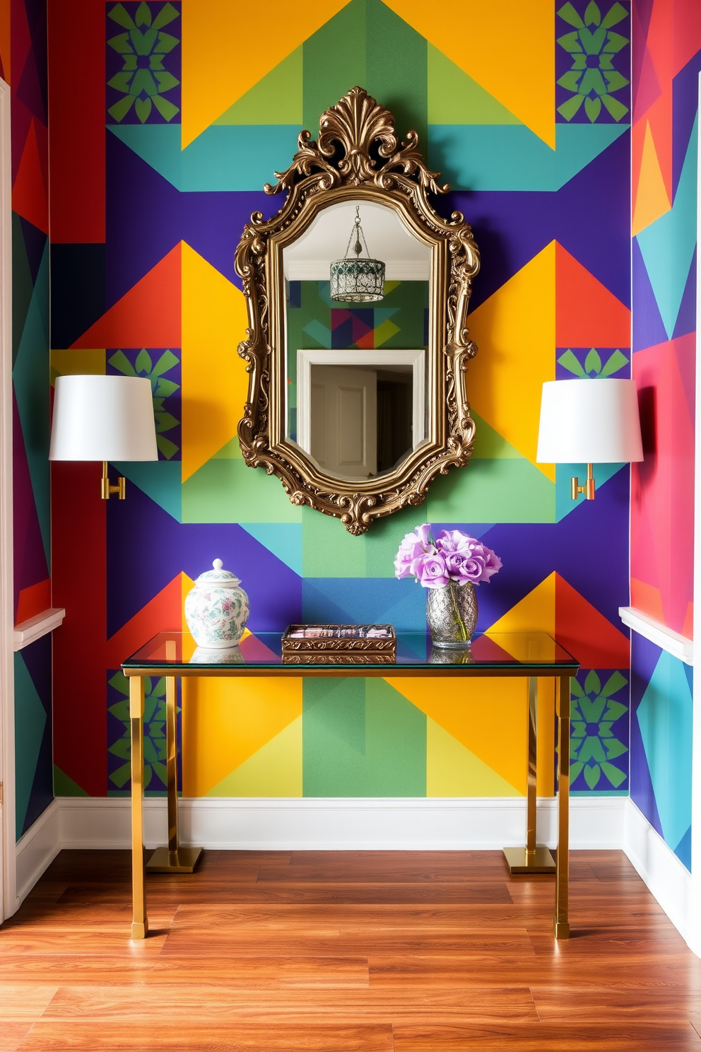 A vibrant accent wall adorned with geometric patterns in bold colors sets the tone for the entryway. Flanking the wall, a sleek console table with a glass top and brass legs provides a stylish surface for decorative items. The floor features rich hardwood that contrasts beautifully with the colorful wall. A statement mirror with an ornate frame hangs above the console, reflecting light and enhancing the space's openness.