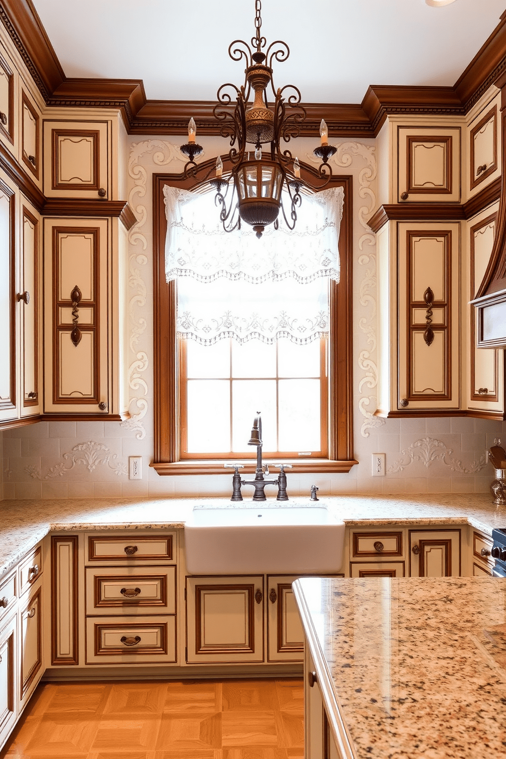 A traditional kitchen featuring ornate detailing on cabinet doors and trim. The cabinets are painted in a soft cream color, complemented by rich wooden accents and intricate moldings. A large farmhouse sink sits beneath a window adorned with lace curtains, allowing natural light to flood the space. The countertops are made of polished granite, while a vintage-style chandelier hangs above the central island, enhancing the kitchen's charm.