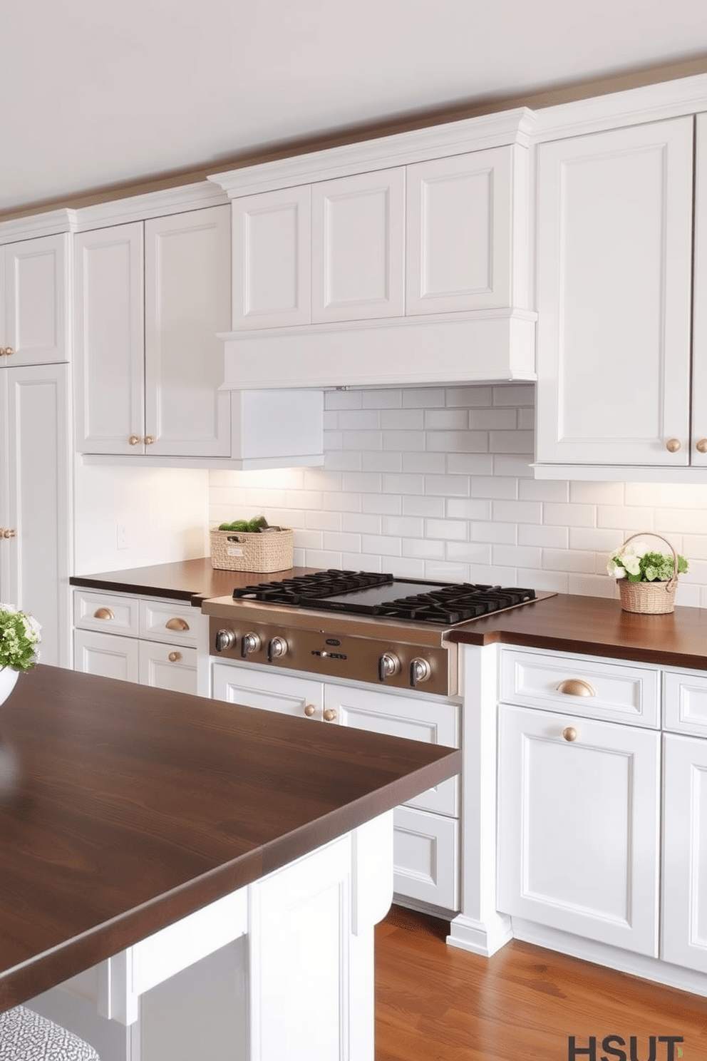 A traditional kitchen design featuring a subway tile backsplash that adds timeless appeal. The cabinetry is painted in a classic white hue, complemented by brass hardware and a spacious island with a dark wood countertop.