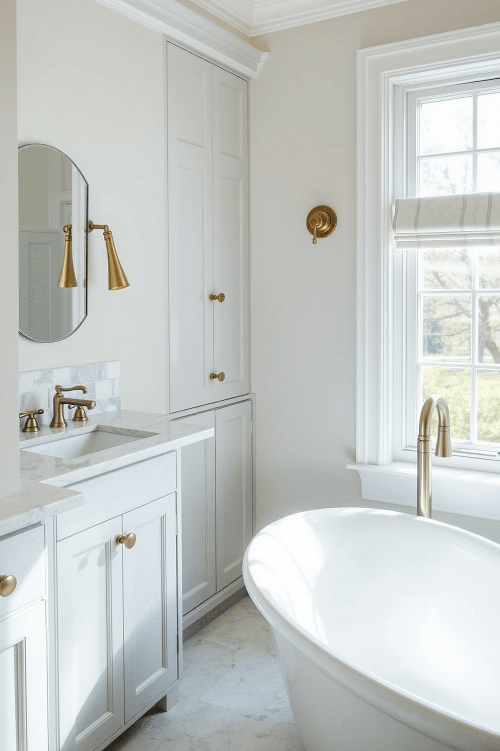 A stylish transitional bathroom featuring a blend of mixed metal finishes. The faucets and cabinet hardware showcase a combination of brushed nickel and antique brass for a trendy aesthetic. The freestanding tub is complemented by a sleek floor-mounted tub filler in a matching finish. Natural light floods the space through a large window, highlighting the elegant tile work and soft color palette.