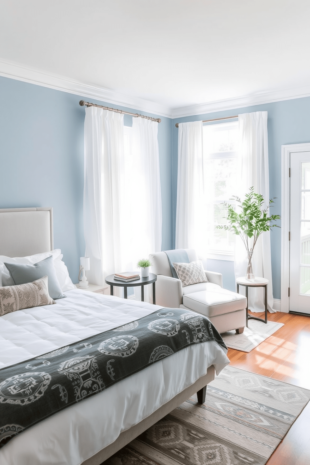 A tranquil bedroom space featuring soft blue walls that create a serene atmosphere. The room includes a plush king-sized bed with a light gray upholstered headboard and crisp white linens. Natural light filters through sheer white curtains, illuminating a cozy reading nook with a comfortable armchair and a small side table. A stylish area rug in muted tones adds warmth to the hardwood floor, enhancing the inviting ambiance.