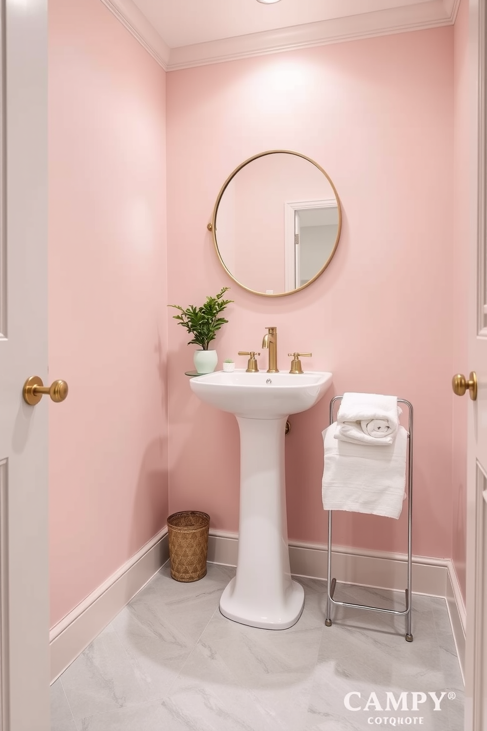 A trendy powder room designed with a soft pastel color palette creates a serene and tranquil atmosphere. The walls are painted in a gentle blush pink, complemented by a sleek white pedestal sink and a round mirror with a delicate gold frame. The flooring features light gray tiles with subtle patterns that enhance the room's elegance. Decorative elements include a small potted plant and a plush white towel neatly arranged on a stylish rack.