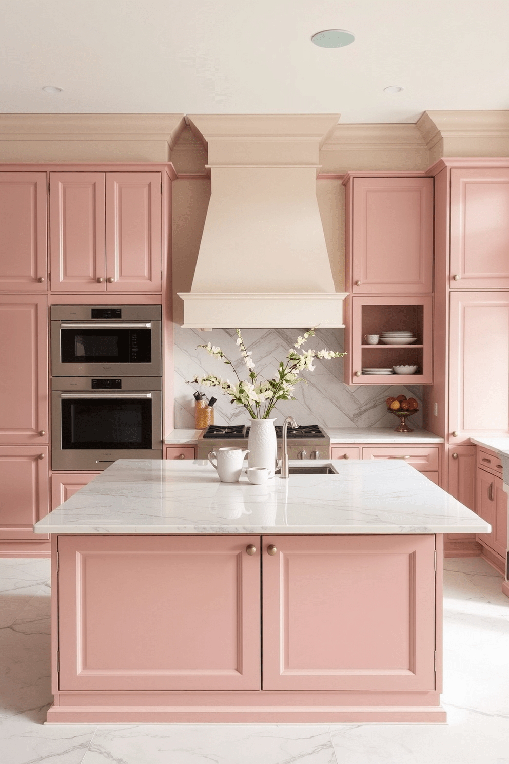 A two-tone kitchen featuring dusty rose and warm cream shades. The cabinetry combines a soft dusty rose on the lower cabinets with warm cream on the upper cabinets, creating a harmonious contrast. The countertops are a light marble with subtle veining that complements the color scheme. A large island in the center is topped with the same marble, providing ample space for cooking and entertaining.