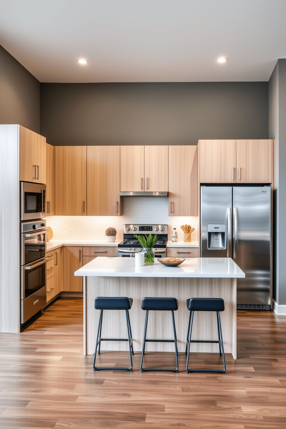 A contemporary U-shaped kitchen featuring stainless steel appliances. The sleek design includes a spacious island in the center with bar stools, complemented by modern cabinetry in a light wood finish.