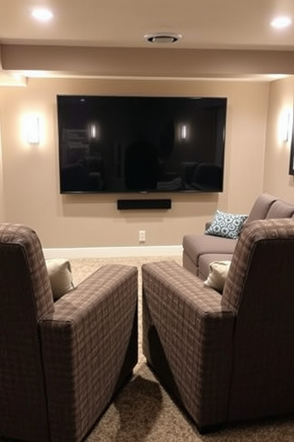 Comfortable lounge chairs for relaxation. The chairs are upholstered in soft, textured fabric and feature wide armrests. Unfinished basement man cave design ideas. The space includes a cozy seating area with a sectional sofa and a large flat-screen TV mounted on the wall.