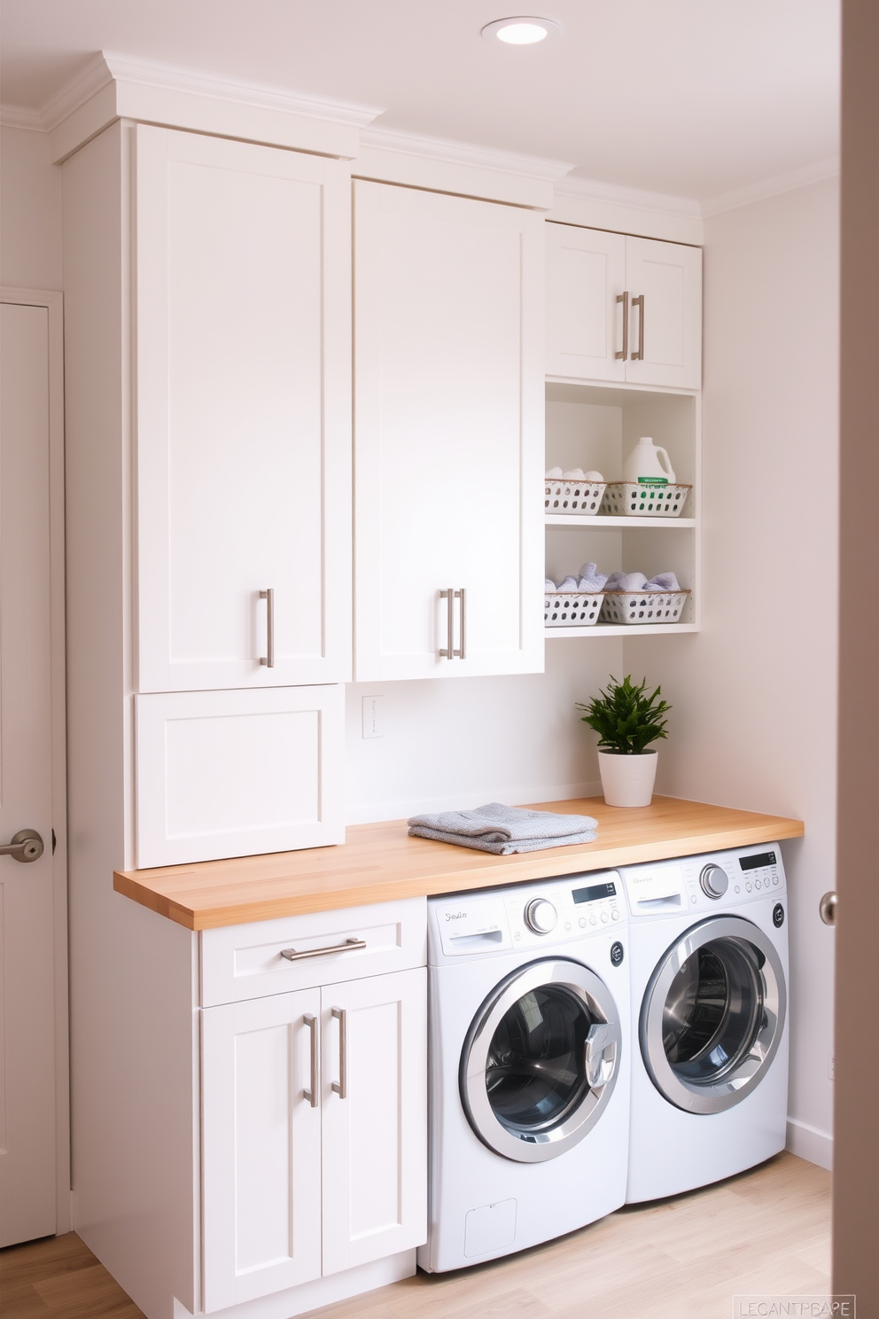 A minimalist utility room laundry room combo features sleek cabinetry in a soft white finish with simple hardware. The space includes a stackable washer and dryer, seamlessly integrated into the cabinetry, and a light wood countertop for folding clothes. The walls are painted in a crisp, neutral tone, enhancing the clean and airy feel of the room. A single potted plant adds a touch of greenery, while open shelving displays neatly organized laundry essentials.