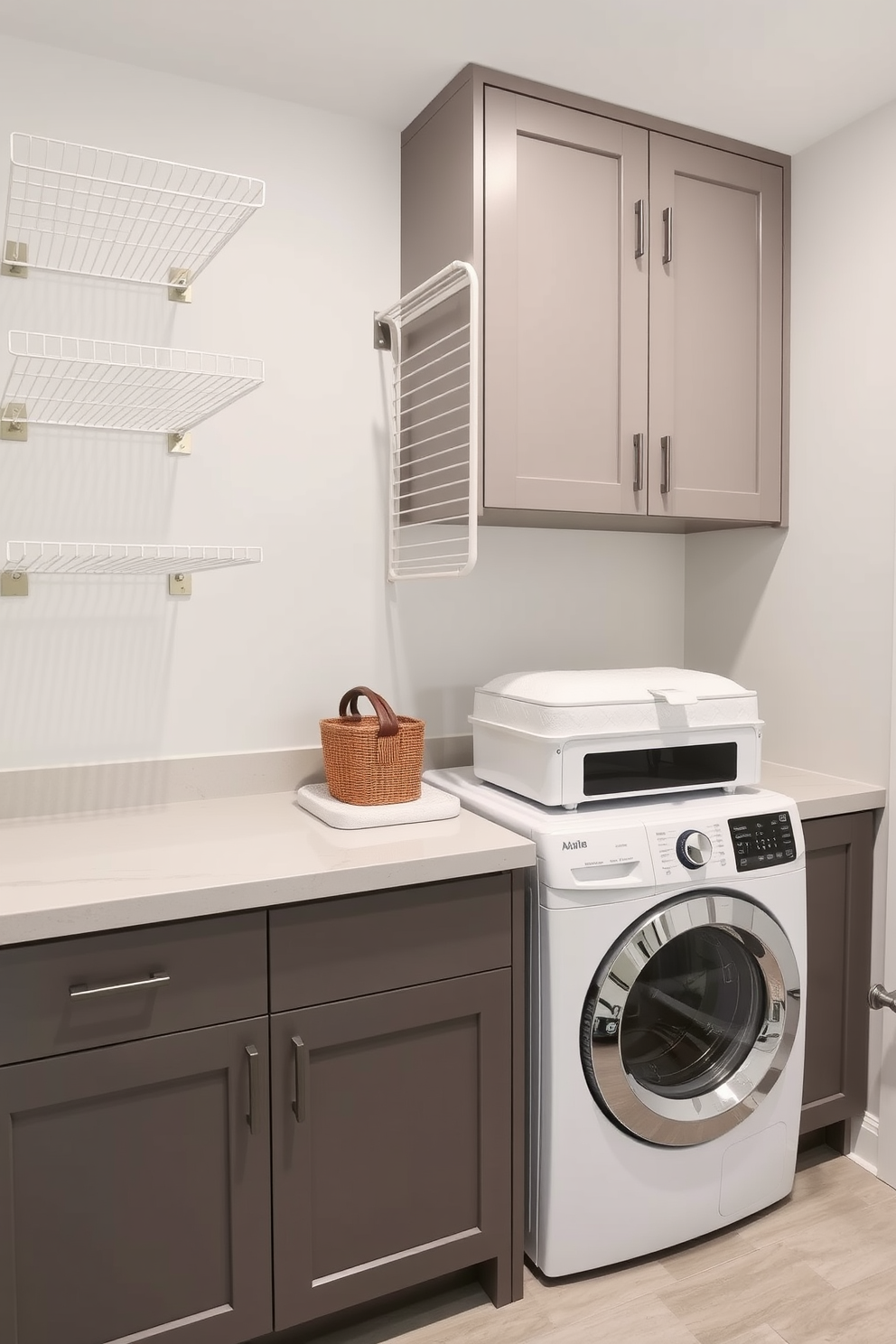 A functional utility room that features wall-mounted drying racks to maximize space efficiency. The laundry area includes a stacked washer and dryer, with a sleek countertop for folding clothes and ample storage cabinets above.