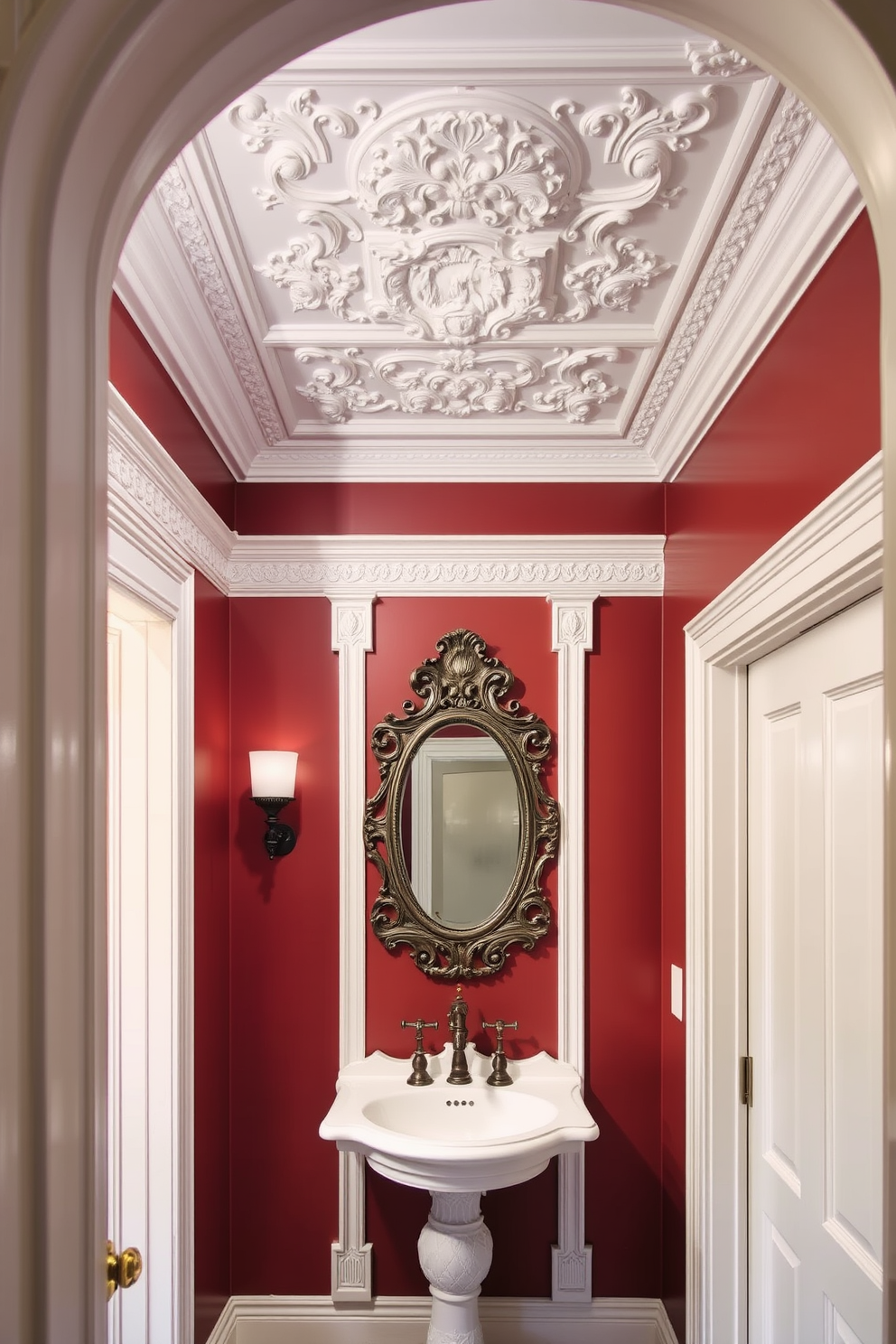 A Victorian powder room features intricate decorative molding along the ceiling and around the doorways, adding elegance and charm to the space. The trim details are painted in a soft white, contrasting beautifully with the rich, deep hues of the wall color. The room showcases a vintage pedestal sink with ornate detailing, complemented by a classic wall-mounted faucet. An antique mirror with a decorative frame hangs above the sink, reflecting the stunning craftsmanship of the molding.