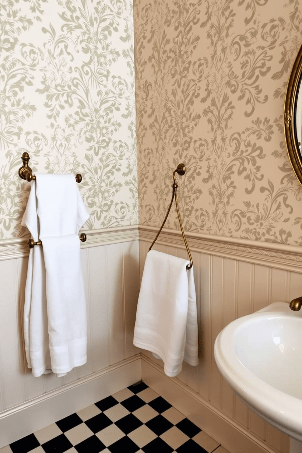 A vintage bathroom setting featuring antique brass towel bars and hooks. The walls are adorned with intricate floral wallpaper, and the floor is covered in classic black and white checkerboard tiles.