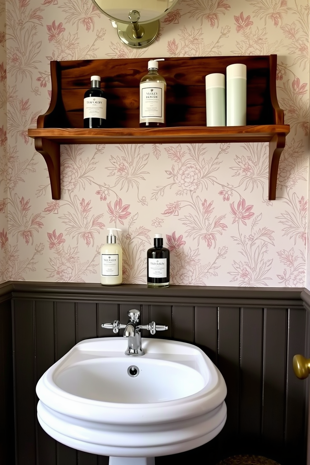 A vintage-inspired powder room featuring elegantly displayed toiletries on a rustic wooden shelf. The walls are adorned with delicate floral wallpaper, and a classic pedestal sink adds charm to the space.