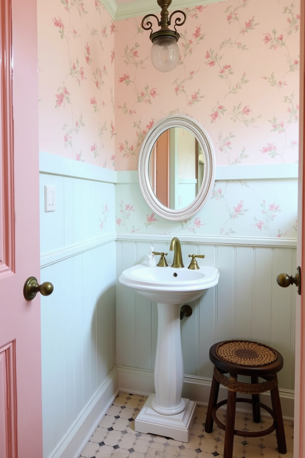 A vintage powder room featuring soft pastel walls in shades of blush and mint. The space is adorned with a classic pedestal sink and a round mirror framed in distressed white wood. Delicate floral wallpaper adds charm, while antique brass fixtures provide a touch of elegance. A small wooden stool with a woven basket sits in the corner, complemented by a vintage-style light fixture overhead.