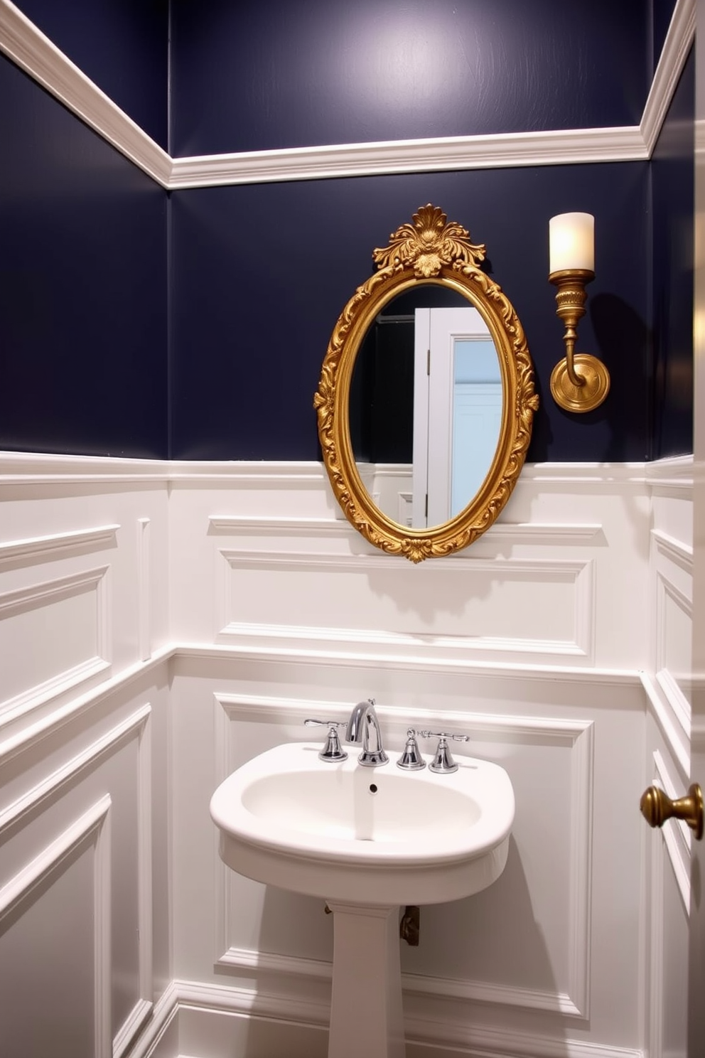 A vintage powder room featuring classic wainscoting that adds elegance and charm. The walls are adorned with intricate molding painted in soft white, contrasting beautifully with the deep navy blue above. A small pedestal sink with a polished chrome faucet sits against the wainscoted wall. A round mirror with an ornate gold frame reflects the warm light from a vintage-style sconce mounted beside it.