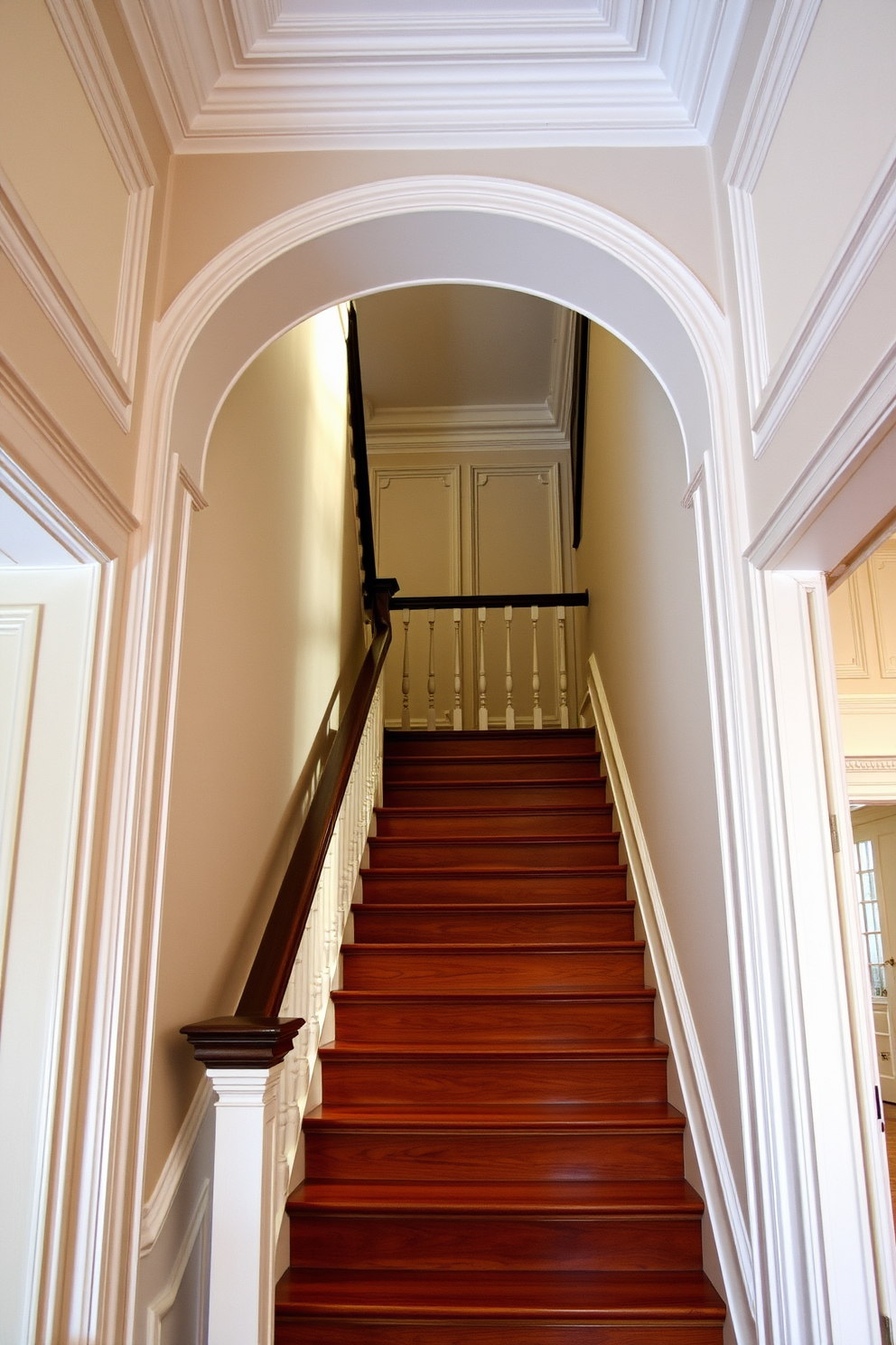 Crown molding elegantly frames the walls of a vintage staircase, enhancing its architectural beauty. The staircase features rich wooden treads and a classic balustrade, creating a warm and inviting atmosphere. The walls are adorned with intricate moldings that add depth and character to the space. Soft, ambient lighting highlights the vintage details, making the staircase a stunning focal point in the home.