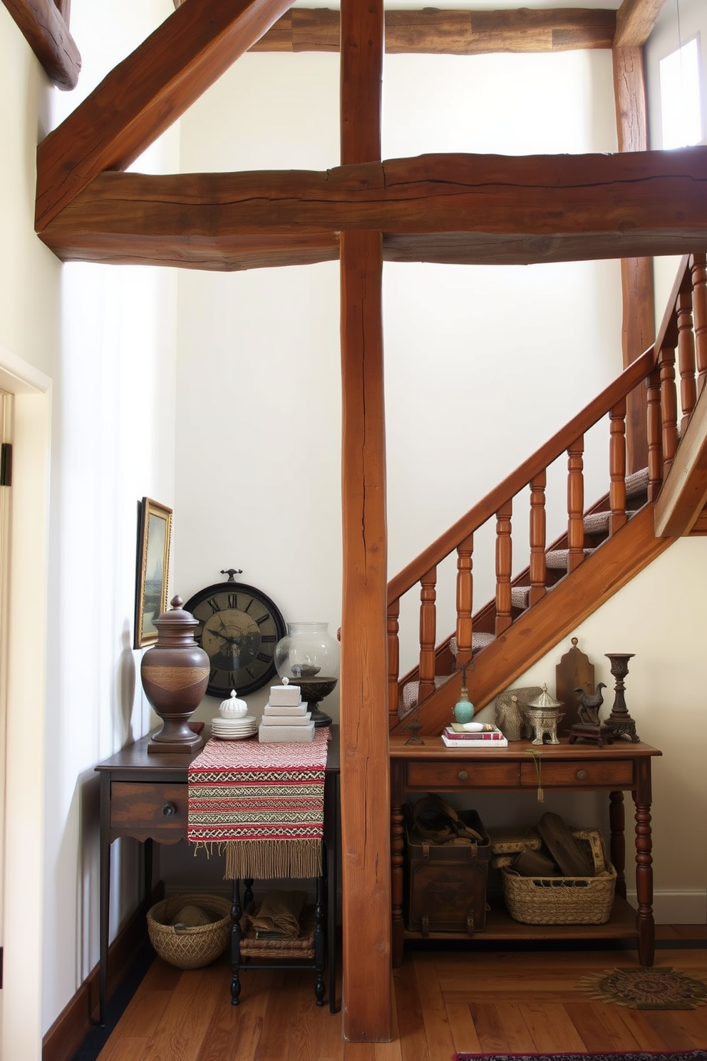 A rustic wooden staircase features exposed beams overhead, creating a warm and inviting atmosphere. The staircase is adorned with a handwoven runner that adds texture and color to the wood. The walls are painted in a soft cream hue, enhancing the natural light that floods the space. At the base of the stairs, a vintage console table displays a collection of antique decor items, adding character to the design.