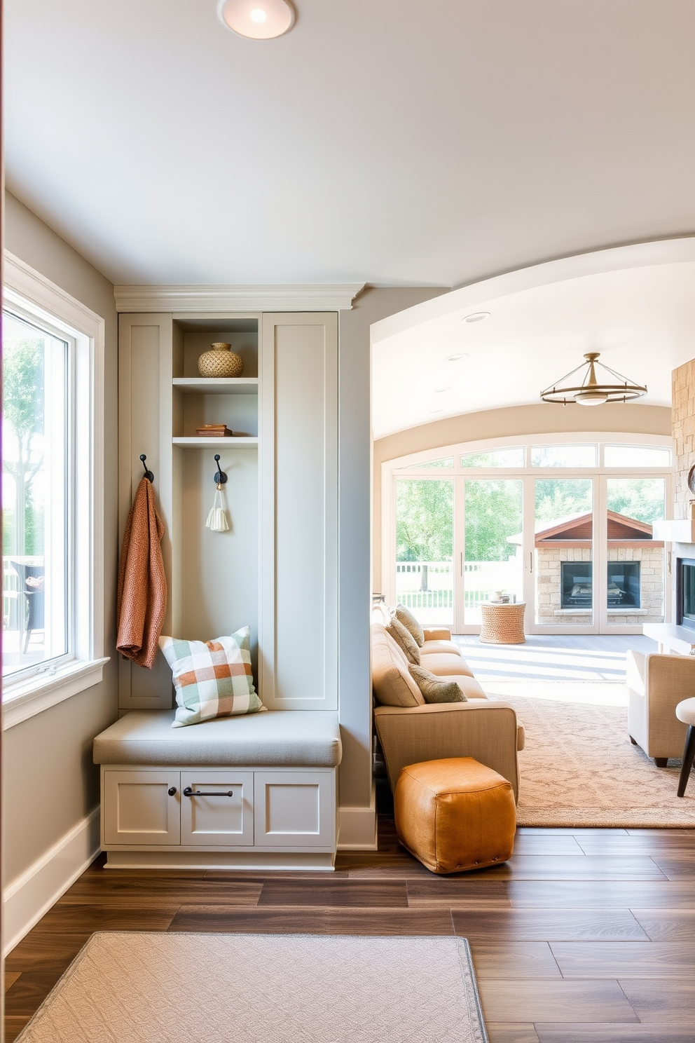 A welcoming entryway features built-in storage solutions that blend seamlessly with the decor. The space is illuminated by natural light streaming through a large window, highlighting a cozy bench and decorative hooks for coats. The walkout basement design includes a spacious lounge area with comfortable seating and a modern fireplace. Large glass doors open to a patio, creating a seamless transition between indoor and outdoor living spaces.