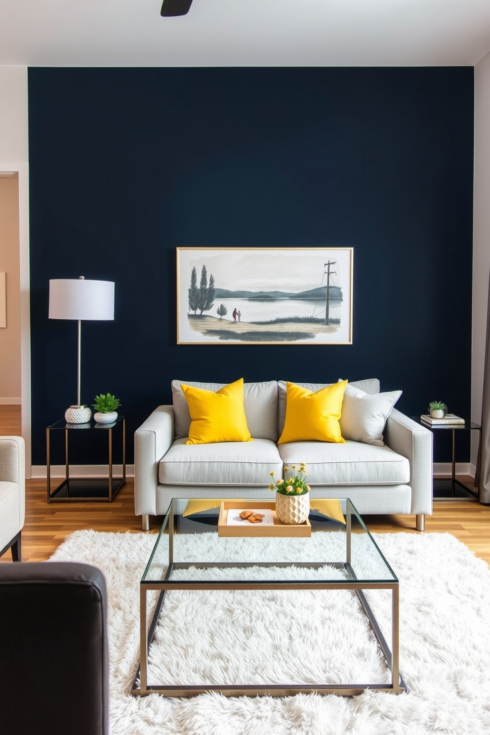 A modern living room featuring neutral tones throughout the furnishings and decor. A bold accent wall painted in deep navy blue creates a striking focal point, enhancing the overall sophistication of the space. The seating arrangement includes a plush light gray sofa paired with vibrant yellow accent pillows. A sleek coffee table made of glass and metal sits atop a soft area rug, adding warmth to the room.