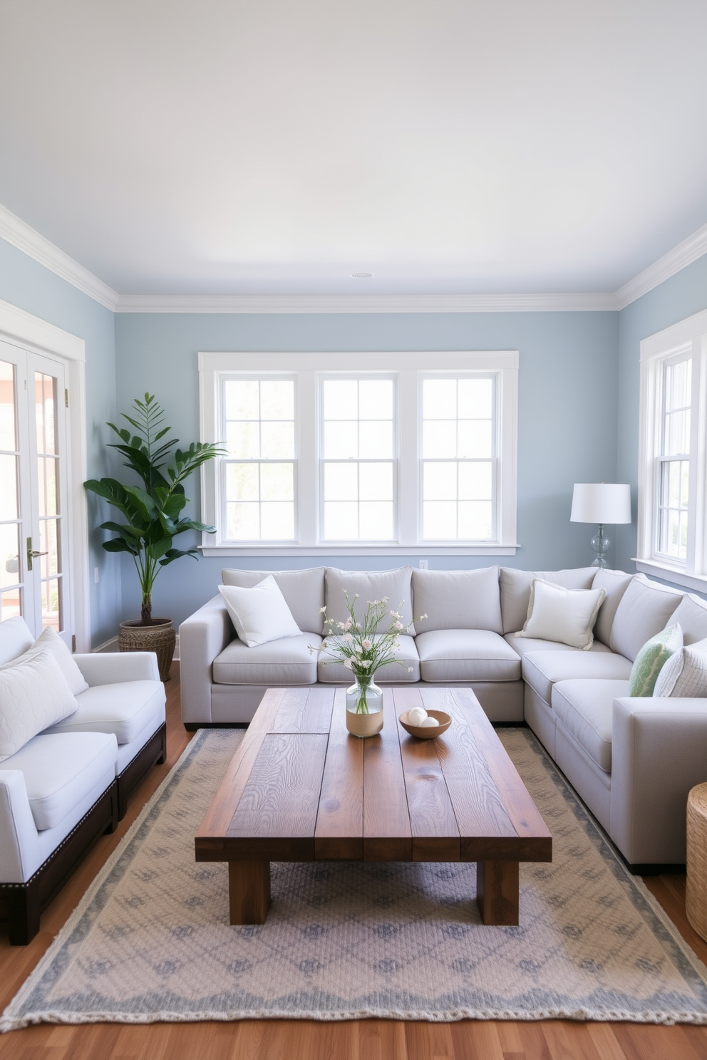 A serene living room featuring pale blue walls that evoke a calming atmosphere. The space is adorned with soft white trim and large windows that let in natural light, enhancing the tranquil vibe. Comfortable seating arrangements include a plush sectional sofa in light gray, accented with pastel-colored throw pillows. A stylish coffee table made of reclaimed wood sits at the center, surrounded by a cozy area rug that complements the overall color scheme.