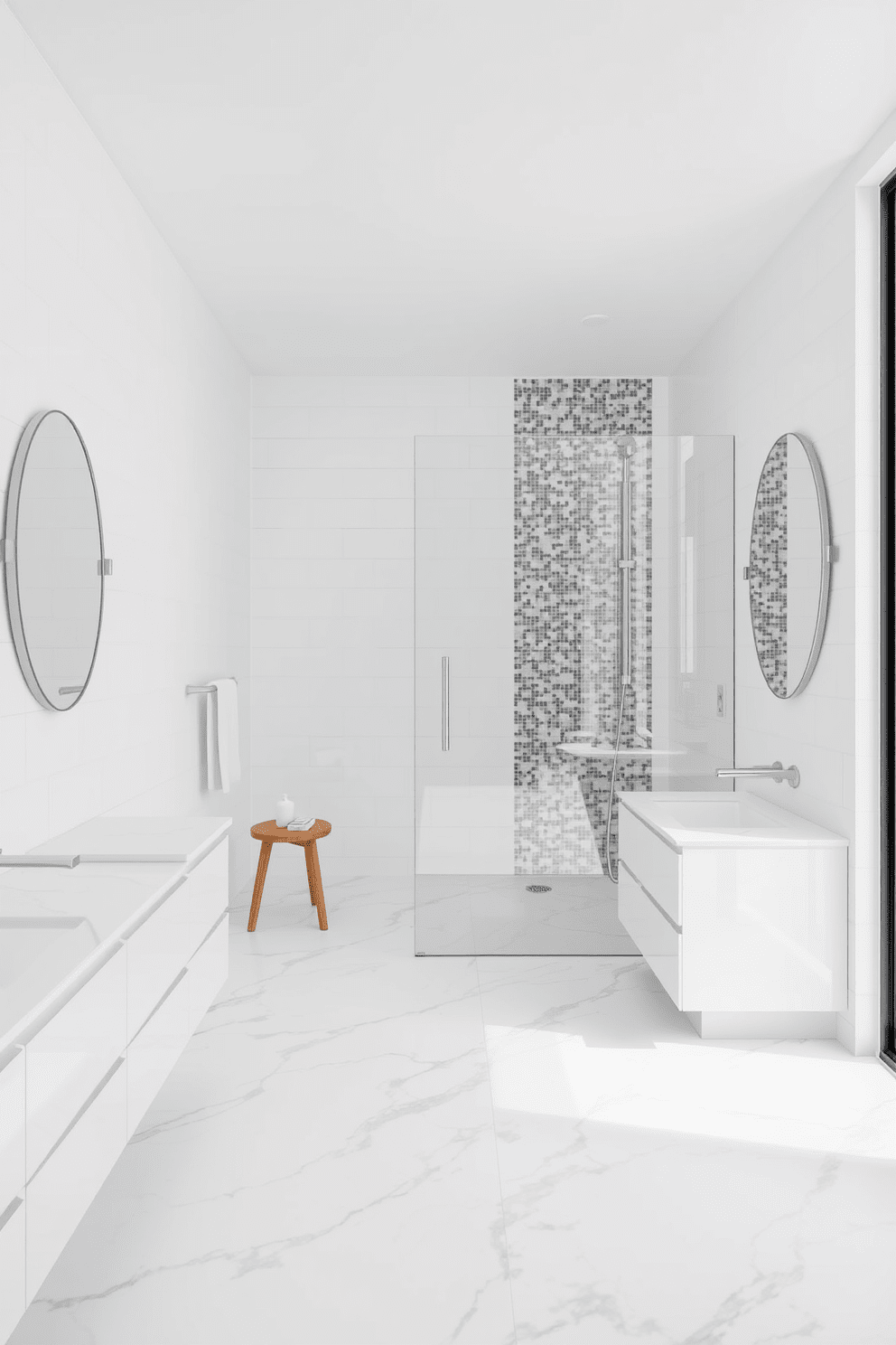 A spacious white bathroom featuring a glass shower enclosure that enhances the open feel of the space. The walls are adorned with large white tiles, and the floor is covered with sleek gray marble for a modern touch.