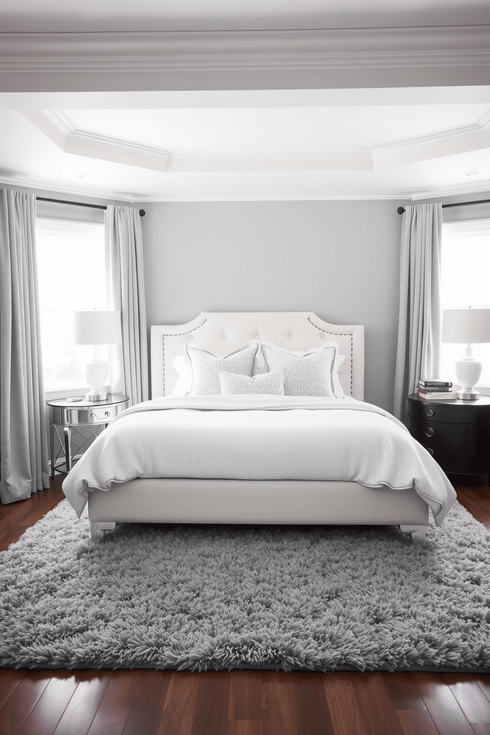 A serene bedroom featuring subtle gray tones against a backdrop of white decor. The walls are painted a soft gray, and the bedding is a crisp white with textured accents. A plush gray area rug lies under a white upholstered bed, creating a cozy focal point. Elegant gray curtains frame the windows, allowing soft natural light to filter in.