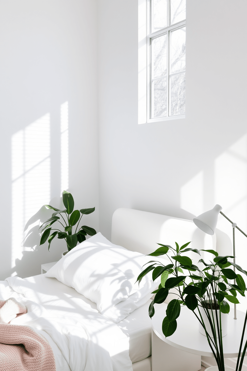 A bright white bedroom filled with natural light creates a serene atmosphere. Lush green plants are strategically placed around the room, adding a touch of freshness and vibrancy. The bed features crisp white linens and a plush headboard, complemented by soft, neutral throw pillows. A minimalist nightstand holds a small potted plant and a stylish lamp, enhancing the room's tranquility.