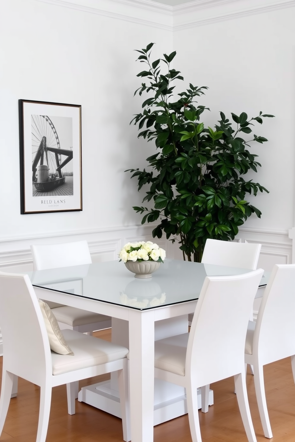 Chic all-white dining set with greenery. The dining table is rectangular with sleek lines, surrounded by elegant white chairs featuring soft cushions. A large potted plant stands in the corner, adding a touch of nature to the space. The walls are painted in a soft white, enhancing the airy and bright atmosphere of the room.