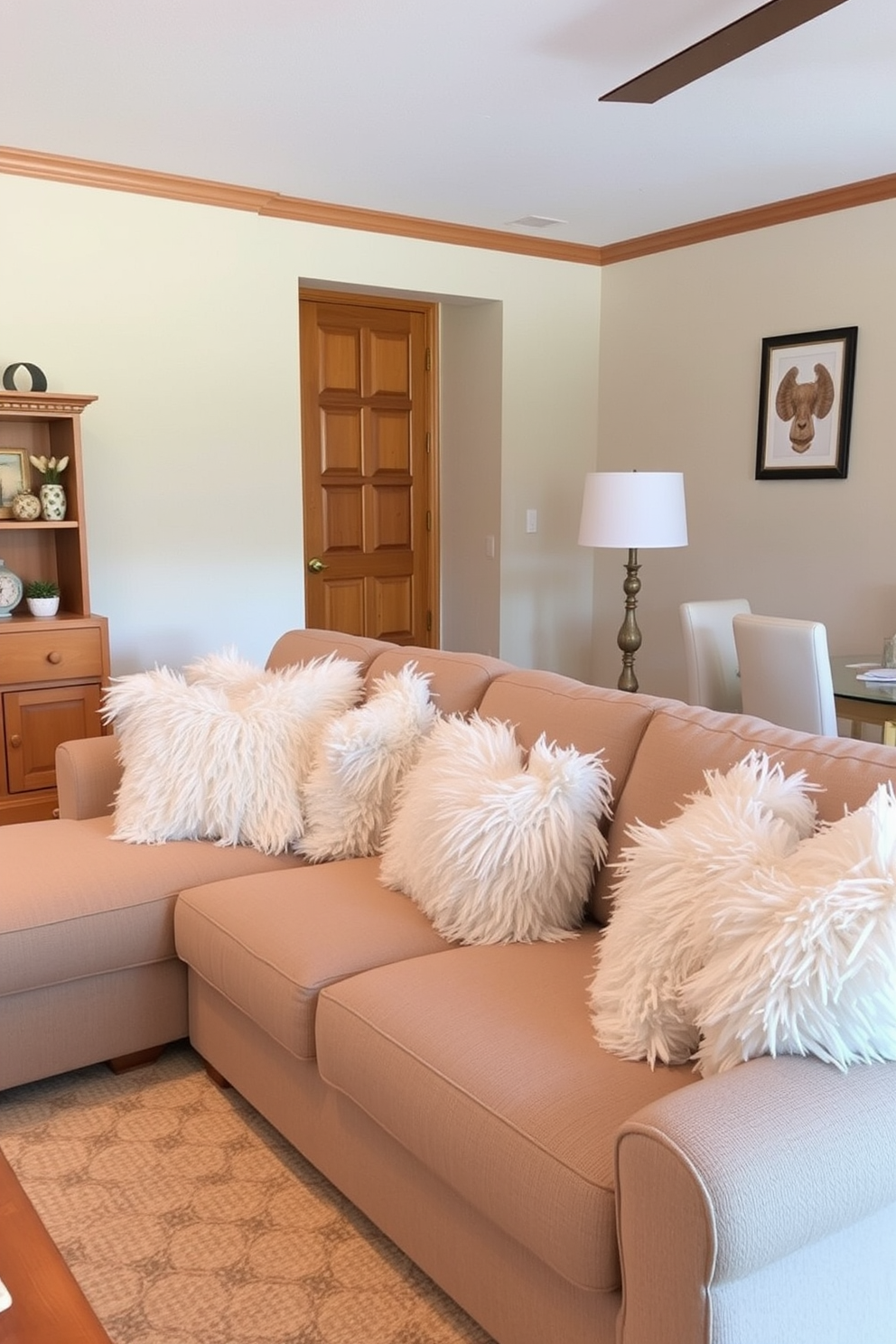 A cozy sectional sofa adorned with fluffy white pillows creates an inviting atmosphere. The walls are painted in a soft beige, complementing the warm wooden accents throughout the space.