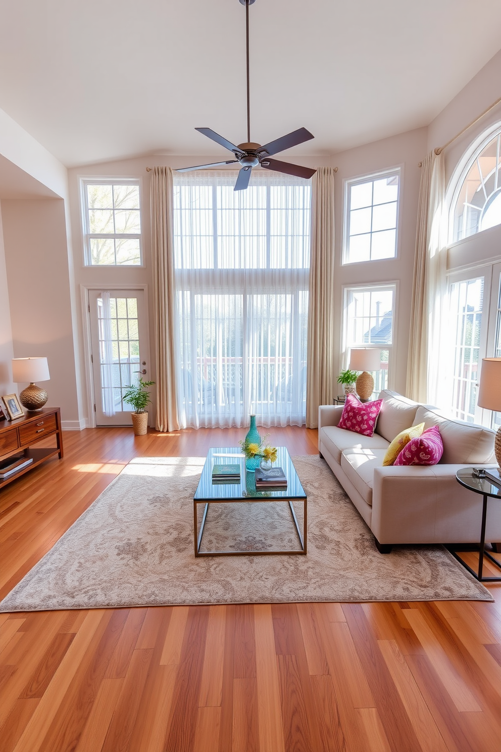 A bright and inviting family room features layered lighting with dimmable options to create the perfect ambiance. The space includes a large sectional sofa in a soft neutral fabric, paired with colorful accent pillows and a stylish coffee table at the center. Warm wood flooring complements the light-colored walls, while a cozy area rug adds texture underfoot. Floor-to-ceiling windows allow natural light to flood the room, and elegant sheer curtains provide privacy while maintaining brightness.